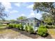 Full pool enclosure with landscaping, promoting outdoor living and recreation in a secluded backyard setting at 15921 Wyndover Rd, Tampa, FL 33647