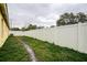 Long white vinyl fence in backyard provides privacy and security for outdoor enjoyment at 1610 Bondurant Way, Brandon, FL 33511