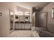 Bathroom featuring double sinks, bathtub, and a separate glass-enclosed shower at 1610 Bondurant Way, Brandon, FL 33511