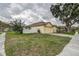 Single-story home with attached garage, white fence, and spacious front yard, perfect for outdoor activities at 1610 Bondurant Way, Brandon, FL 33511