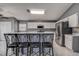 Bright kitchen featuring a center island with seating, white cabinets, and stainless steel appliances at 1610 Bondurant Way, Brandon, FL 33511