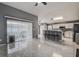 Open-concept living room showcasing tile floors, sliding glass doors, and a modern kitchen at 1610 Bondurant Way, Brandon, FL 33511