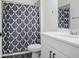 Bathroom with vanity, shower with stylish blue patterned shower curtain at 16247 November Rain Ct, Land O Lakes, FL 34638