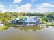 Aerial view of the lakeside community clubhouse featuring a lake view and modern architectural design at 16247 November Rain Ct, Land O Lakes, FL 34638