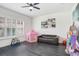 Playful living room with dark wood floors, pink tent, and natural light at 16247 November Rain Ct, Land O Lakes, FL 34638