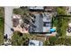 This is a detailed aerial view of a charming home with a screened-in porch and inviting pool area at 1859 Oklahoma Ne Ave, St Petersburg, FL 33703
