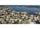 An aerial view showcasing a waterfront neighborhood with direct ocean access, lush trees, and well-kept properties at 1859 Oklahoma Ne Ave, St Petersburg, FL 33703