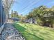 Well-manicured backyard features artificial turf, a seating area, and a hammock for outdoor enjoyment at 1859 Oklahoma Ne Ave, St Petersburg, FL 33703