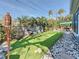 This backyard features artificial turf, tropical plants, and a sunshade-covered seating area at 1859 Oklahoma Ne Ave, St Petersburg, FL 33703