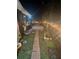 Backyard features a brick path and green grass with an installed irrigation system at 1859 Oklahoma Ne Ave, St Petersburg, FL 33703