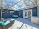 Inviting covered patio area with a comfortable seating and dining, and outdoor lighting for evening enjoyment at 1859 Oklahoma Ne Ave, St Petersburg, FL 33703