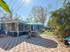 Outdoor entertaining area with shaded seating and an outdoor kitchen, perfect for gatherings and relaxation at 1859 Oklahoma Ne Ave, St Petersburg, FL 33703