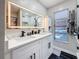 Stylish bathroom featuring double sinks, quartz countertop, illuminated mirror, and modern fixtures at 1859 Oklahoma Ne Ave, St Petersburg, FL 33703