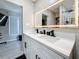 Contemporary bathroom with double sinks, a spacious quartz countertop, and modern lighting at 1859 Oklahoma Ne Ave, St Petersburg, FL 33703