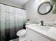 Well-lit bathroom with a modern vanity, stylish mirror, and a shower with a decorative curtain at 1859 Oklahoma Ne Ave, St Petersburg, FL 33703