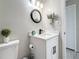 Bathroom featuring a round mirror, quartz countertop, a decorative hand towel, and gray waterproof flooring at 1859 Oklahoma Ne Ave, St Petersburg, FL 33703