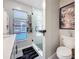 Bright bathroom featuring glass shower, toilet, modern decor and a window to bring in light and fresh air at 1859 Oklahoma Ne Ave, St Petersburg, FL 33703