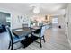 Modern dining room open to the kitchen, featuring wood-look floors and a contemporary chandelier at 1859 Oklahoma Ne Ave, St Petersburg, FL 33703