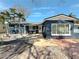 Charming single Gathering home with white trim, palm trees, and inviting outdoor seating area at 1859 Oklahoma Ne Ave, St Petersburg, FL 33703
