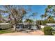 Charming single-story home featuring a large front yard, mature trees, and a paved driveway leading to the entrance at 1859 Oklahoma Ne Ave, St Petersburg, FL 33703