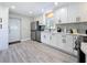 Bright kitchen with white cabinets, stainless steel appliances, ample counter space, and modern backsplash at 1859 Oklahoma Ne Ave, St Petersburg, FL 33703
