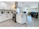 Updated kitchen with white cabinetry, stainless steel appliances, and a view into the living room at 1859 Oklahoma Ne Ave, St Petersburg, FL 33703