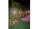 Landscape along side the house has green lawn and tropical plants with a brick paver pathway at 1859 Oklahoma Ne Ave, St Petersburg, FL 33703