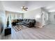 Inviting living room featuring modern flooring, a ceiling fan, and large windows that bring in natural light at 1859 Oklahoma Ne Ave, St Petersburg, FL 33703