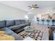 Inviting living room featuring a comfortable gray sofa, stylish rug, and open layout leading to the kitchen at 1859 Oklahoma Ne Ave, St Petersburg, FL 33703
