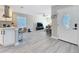 Open-concept living space with kitchen island, breakfast bar, and modern furnishings at 1859 Oklahoma Ne Ave, St Petersburg, FL 33703