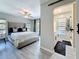 Comfortable main bedroom with a ceiling fan, a plush headboard, and sliding glass doors to a patio at 1859 Oklahoma Ne Ave, St Petersburg, FL 33703