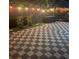 Lovely brick patio featuring lush potted plants and ambient string lights at 1859 Oklahoma Ne Ave, St Petersburg, FL 33703