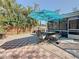 Outdoor patio with brick pavers, dining set with blue umbrella, and fenced backyard offers privacy and space for entertaining at 1859 Oklahoma Ne Ave, St Petersburg, FL 33703