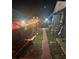View of the property's side yard with garden, brick path, wooden fence, and updated AC unit at 1859 Oklahoma Ne Ave, St Petersburg, FL 33703