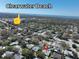 Aerial view of Clearwater Beach, with lush trees and quaint houses with pools at 1906 Del Oro Ct, Dunedin, FL 34698