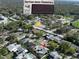 Aerial view of a home near Garrison-Jones Elementary, surrounded by lush trees and well-kept neighborhood at 1906 Del Oro Ct, Dunedin, FL 34698