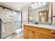 This bathroom is equipped with granite countertops, a glass shower, and sleek light fixtures at 1906 Del Oro Ct, Dunedin, FL 34698