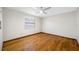 Cozy bedroom with a ceiling fan, hardwood floors, and a window at 1906 Del Oro Ct, Dunedin, FL 34698