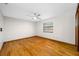 Bright bedroom with hardwood floors, ceiling fan, and a large window at 1906 Del Oro Ct, Dunedin, FL 34698