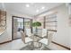 Bright dining area with glass table and chairs, leading to a screened lanai at 1906 Del Oro Ct, Dunedin, FL 34698