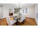 Inviting dining area featuring a stylish chandelier, a wooden table with 6 chairs, and decorative artwork at 1906 Del Oro Ct, Dunedin, FL 34698