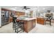 Spacious kitchen boasts ample counter space, stainless steel appliances, and a large center island with seating at 1906 Del Oro Ct, Dunedin, FL 34698