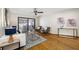 Bright living room with hardwood floors, neutral walls, and sliding glass doors leading to outdoor pool area at 1906 Del Oro Ct, Dunedin, FL 34698