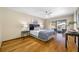Relax in the main bedroom with hardwood floors and sliding glass doors that lead to the pool area at 1906 Del Oro Ct, Dunedin, FL 34698