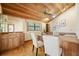 Home office features a wood-paneled ceiling, a built-in desk, and natural light at 1906 Del Oro Ct, Dunedin, FL 34698