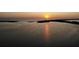 Beautiful sunset over water featuring a vibrant sun reflecting off of the serene seascape at 1906 Del Oro Ct, Dunedin, FL 34698