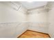 Walk-in closet with white wire shelving and hardwood floors; ready for organized storage at 1906 Del Oro Ct, Dunedin, FL 34698