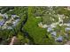 Lush aerial view of a neighborhood featuring mature trees and a winding waterway at 1912 Sandstone Pl, Clearwater, FL 33760