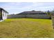 Large backyard features a well-maintained lawn and a privacy fence for outdoor enjoyment at 19730 Preservation Woods Dr, Lutz, FL 33558