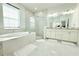 Bright bathroom with double vanity, shower, and modern finishes at 19730 Preservation Woods Dr, Lutz, FL 33558